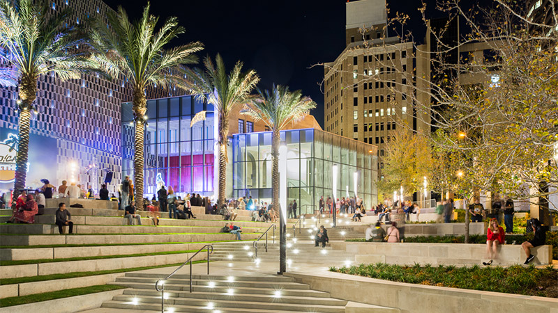Nighttime photo of people in the plaza